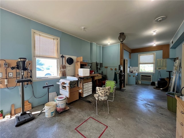 miscellaneous room with a wall mounted air conditioner and plenty of natural light