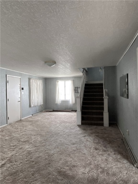 basement with carpet floors, a textured ceiling, and ornamental molding