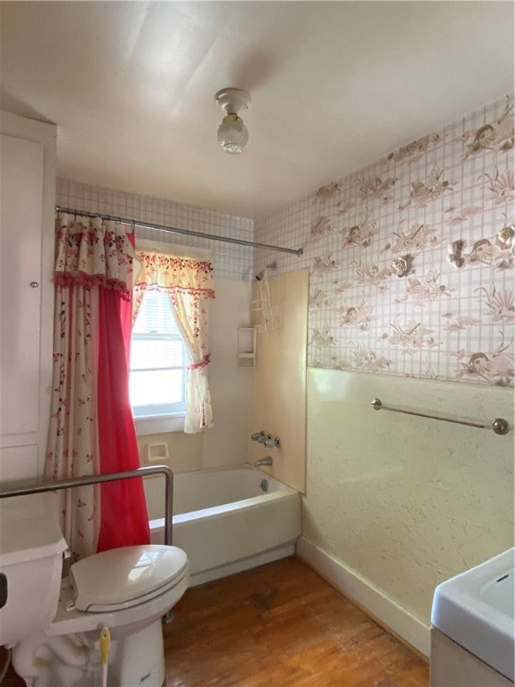 bathroom featuring shower / bath combination with curtain, wood-type flooring, and toilet