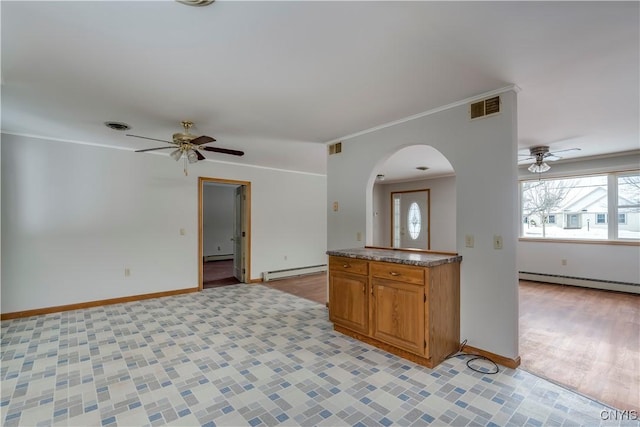 kitchen with ceiling fan, a baseboard radiator, and ornamental molding