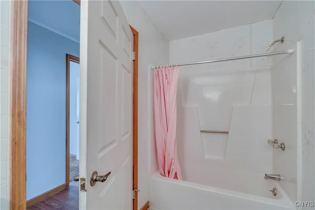 bathroom with wood-type flooring and shower / bath combo