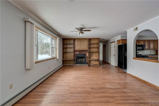 unfurnished living room featuring baseboard heating, ceiling fan, ornamental molding, and light wood-type flooring