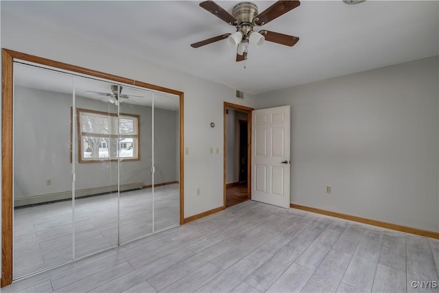 unfurnished bedroom with a baseboard radiator, ceiling fan, light hardwood / wood-style floors, and a closet