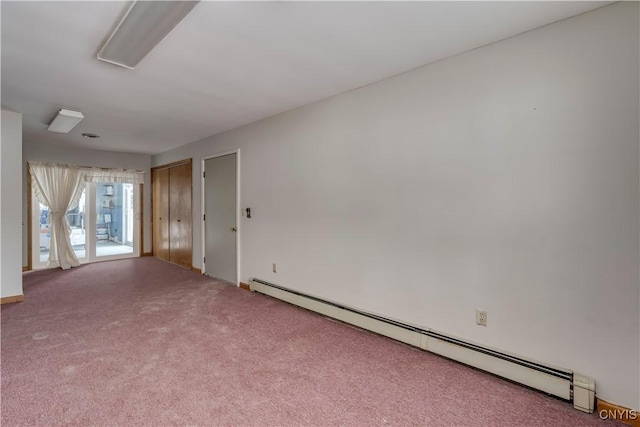 unfurnished room featuring carpet flooring and baseboard heating