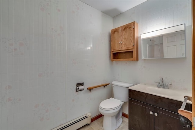 bathroom featuring tile patterned flooring, vanity, a baseboard heating unit, and toilet