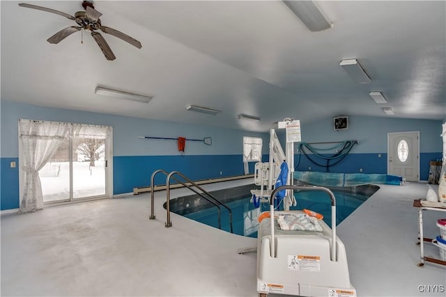 view of swimming pool featuring ceiling fan and a jacuzzi