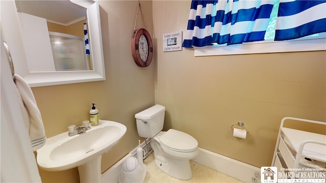 bathroom with tile floors, sink, and toilet