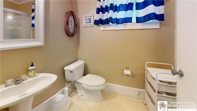 bathroom with sink, tile flooring, and toilet