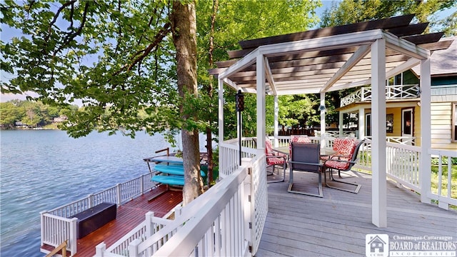 wooden terrace with a pergola and a water view