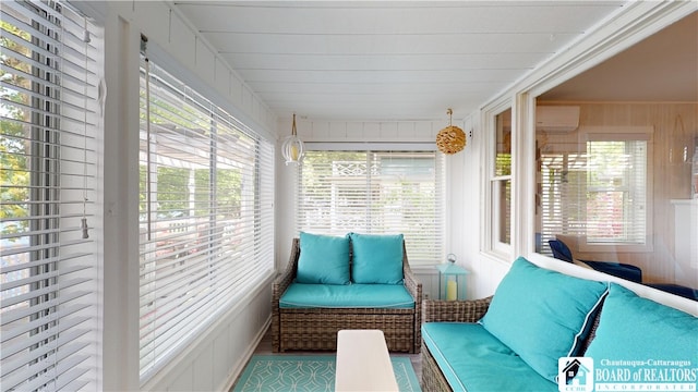 sunroom / solarium with a wealth of natural light and a wall unit AC