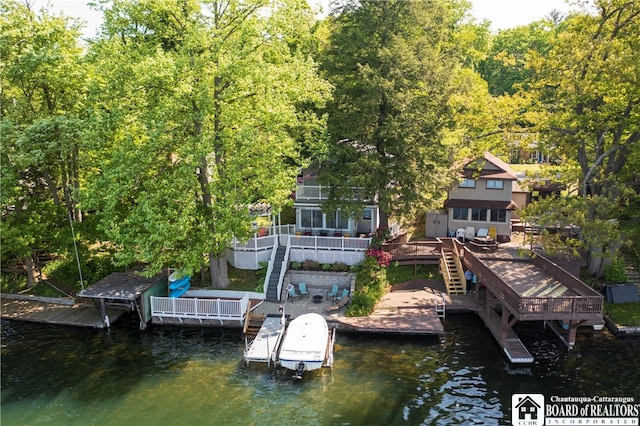 rear view of property with a deck with water view