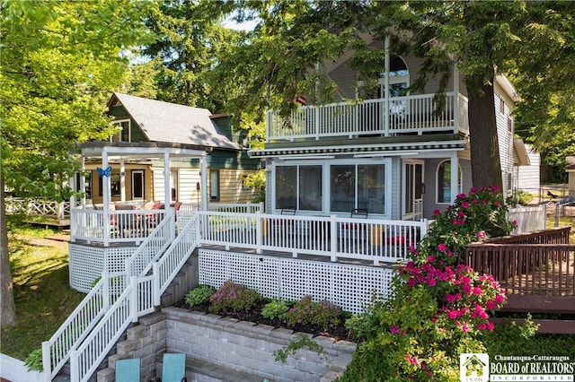 back of property with a balcony