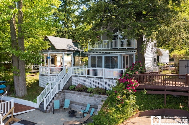 back of house featuring a patio and a wooden deck