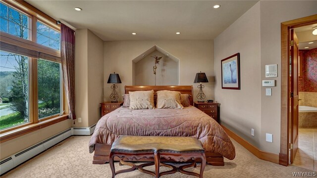 carpeted bedroom featuring ensuite bathroom, baseboard heating, and multiple windows