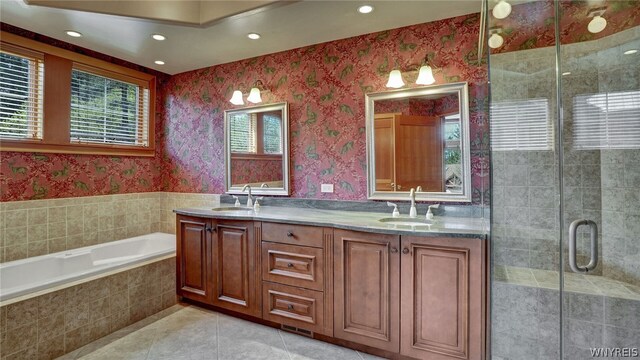 bathroom with tile patterned floors, vanity, and plus walk in shower