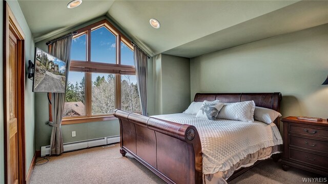 bedroom featuring baseboard heating, light carpet, and vaulted ceiling