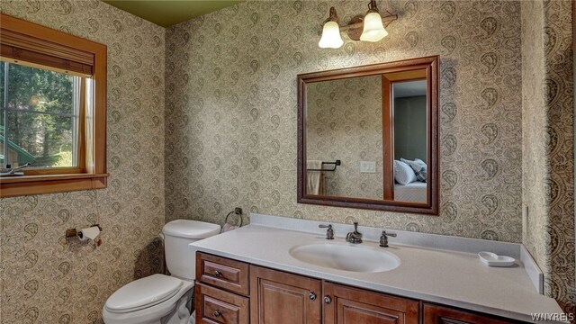 bathroom featuring vanity and toilet