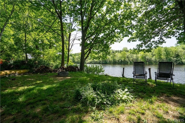 view of dock featuring a water view and an outdoor fire pit