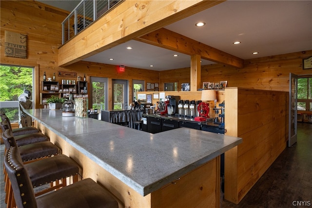 kitchen with a breakfast bar and wooden walls