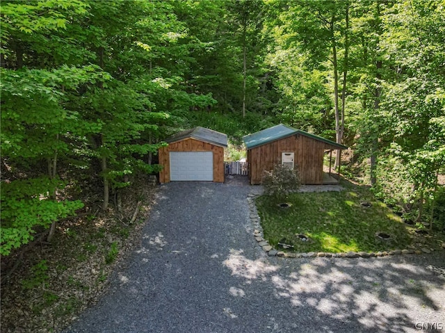 single story home featuring a garage and an outdoor structure