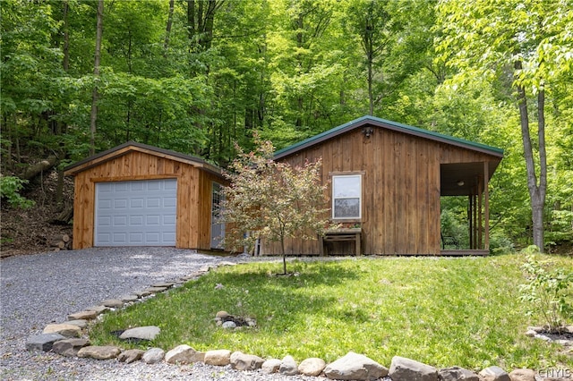 front of property with a front lawn, a garage, and an outdoor structure