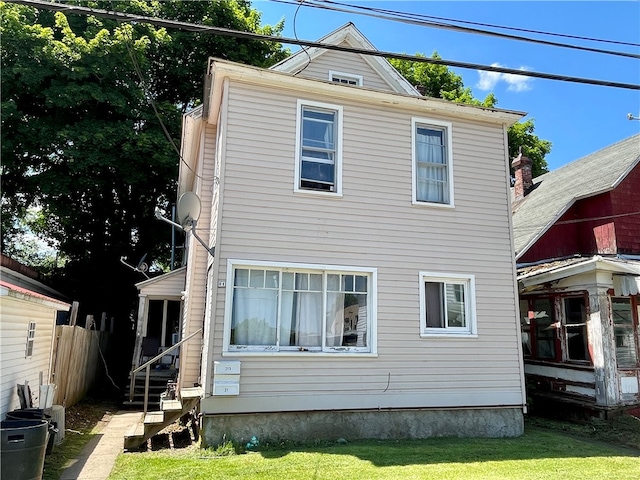 rear view of property with a lawn