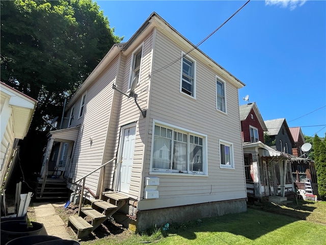 rear view of house with a lawn