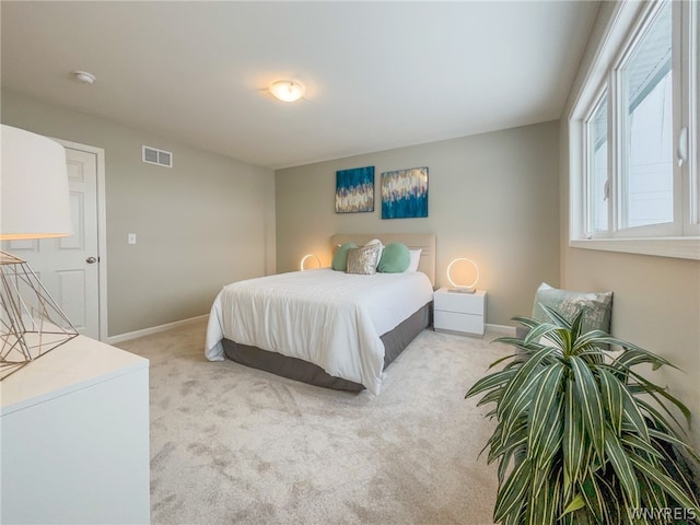 bedroom featuring light carpet