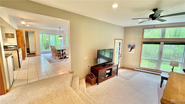 living room featuring ceiling fan, baseboard heating, and light carpet