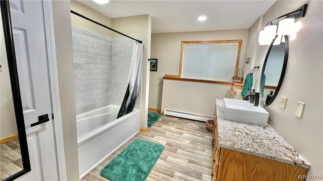 bathroom featuring hardwood / wood-style floors, vanity, a baseboard radiator, and shower / tub combo with curtain