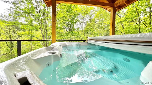 view of pool with a hot tub