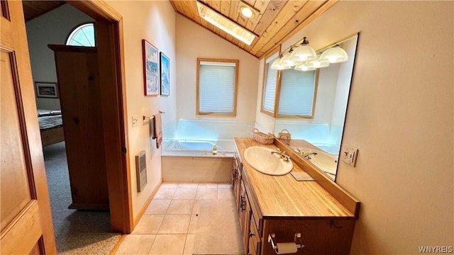 bathroom with tile patterned flooring, tiled bath, vaulted ceiling with skylight, vanity, and wood ceiling