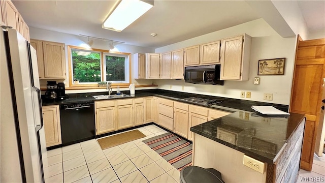 kitchen featuring black appliances, sink, light tile patterned floors, light brown cabinetry, and kitchen peninsula