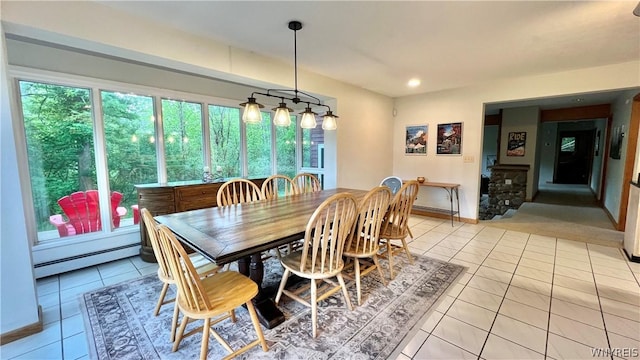 dining room featuring light tile patterned floors and a baseboard heating unit