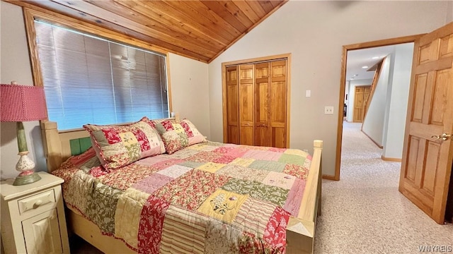 bedroom with lofted ceiling, wooden ceiling, light carpet, and a closet