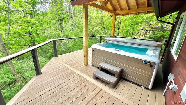 wooden terrace featuring a hot tub