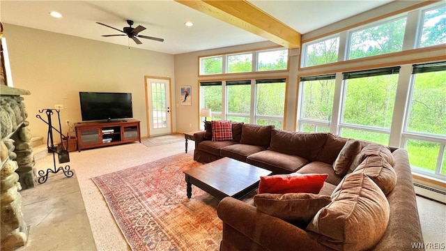 living room featuring beamed ceiling, plenty of natural light, and ceiling fan