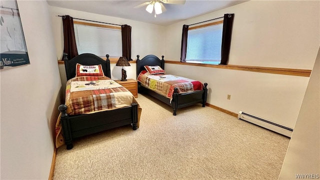 carpeted bedroom featuring ceiling fan and a baseboard radiator