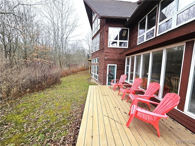 wooden terrace featuring a lawn