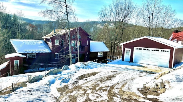 view of front of house featuring a garage and an outdoor structure