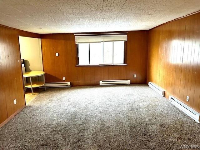 unfurnished room with a baseboard radiator and wooden walls