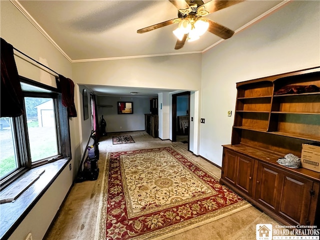 interior space with ceiling fan and ornamental molding