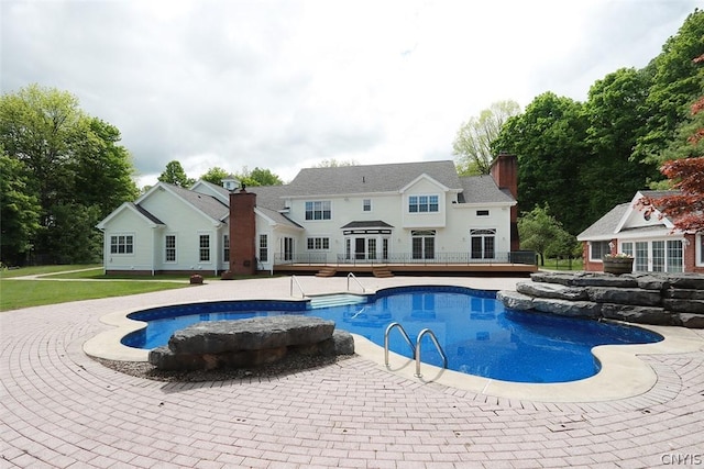 view of swimming pool with a wooden deck