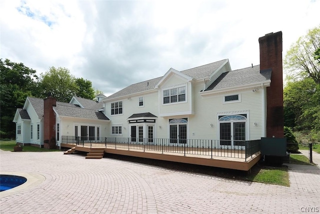 rear view of property with a wooden deck