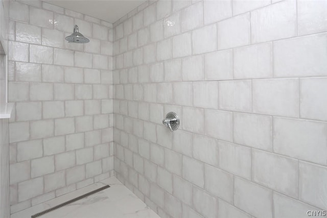 bathroom with a tile shower