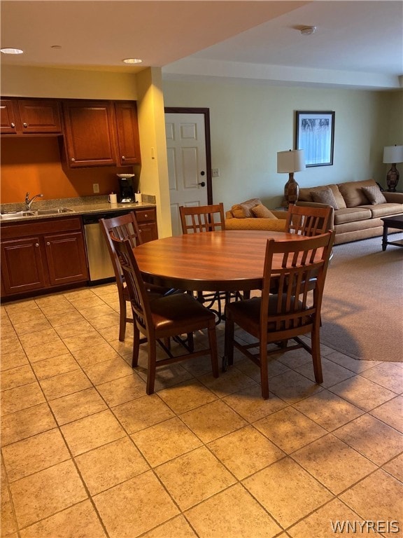 dining room featuring sink and light tile floors