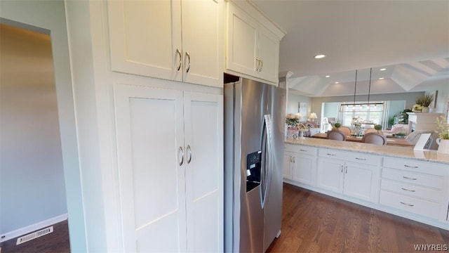 kitchen with light stone counters, recessed lighting, dark wood-type flooring, white cabinetry, and stainless steel refrigerator with ice dispenser