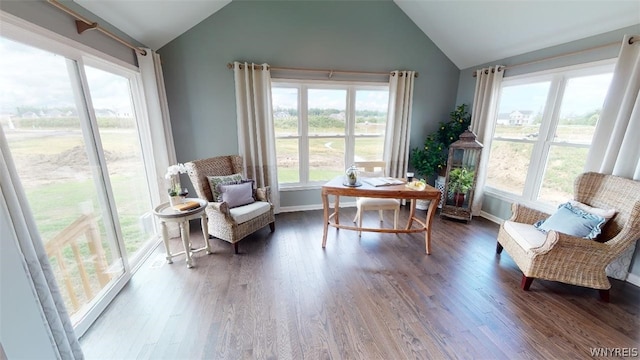 sitting room with dark wood-style floors, lofted ceiling, and baseboards