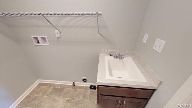 laundry area featuring washer hookup, a sink, gas dryer hookup, laundry area, and baseboards