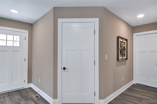 entryway with dark hardwood / wood-style flooring